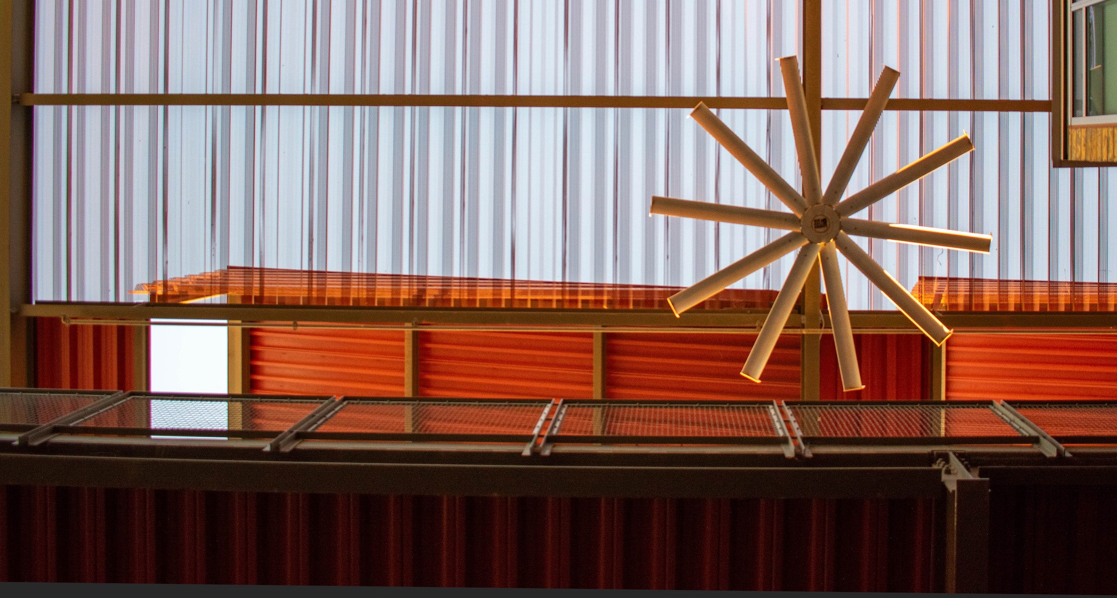 Large circular ceiling fan in a structure made of industrial metal structures