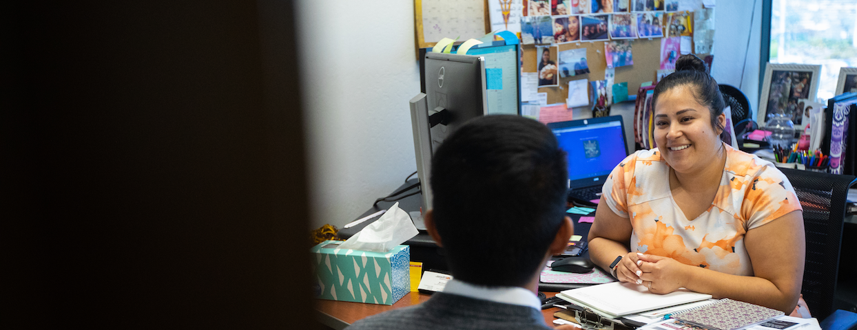 Advisor speaking with a student in her office