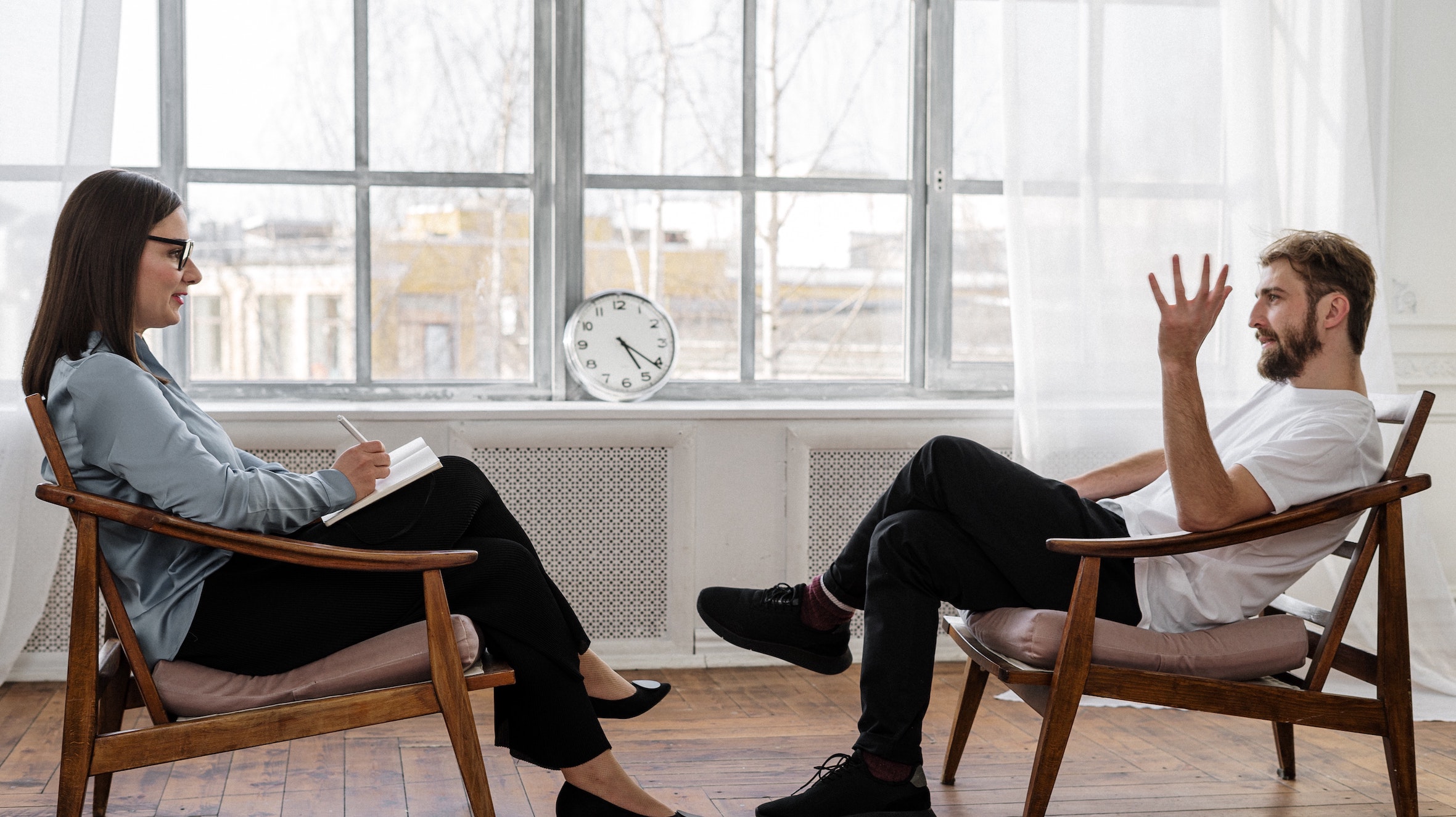 Two people sitting across form each other having a conversation