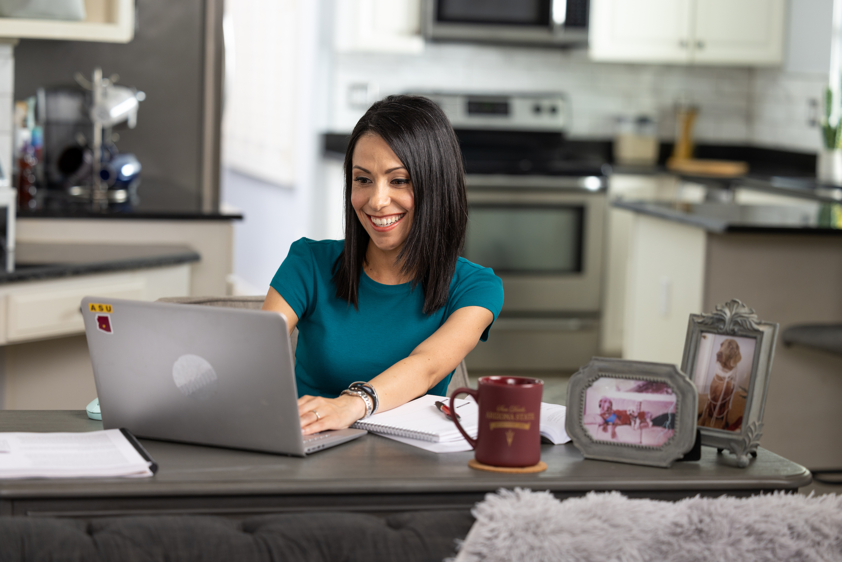 Woman sitting at a desk with a computer.