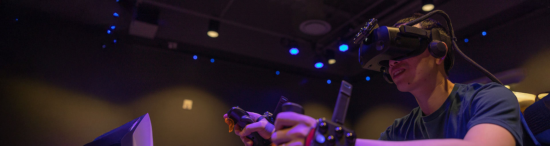 Student wearing a V-R headset in a dark room