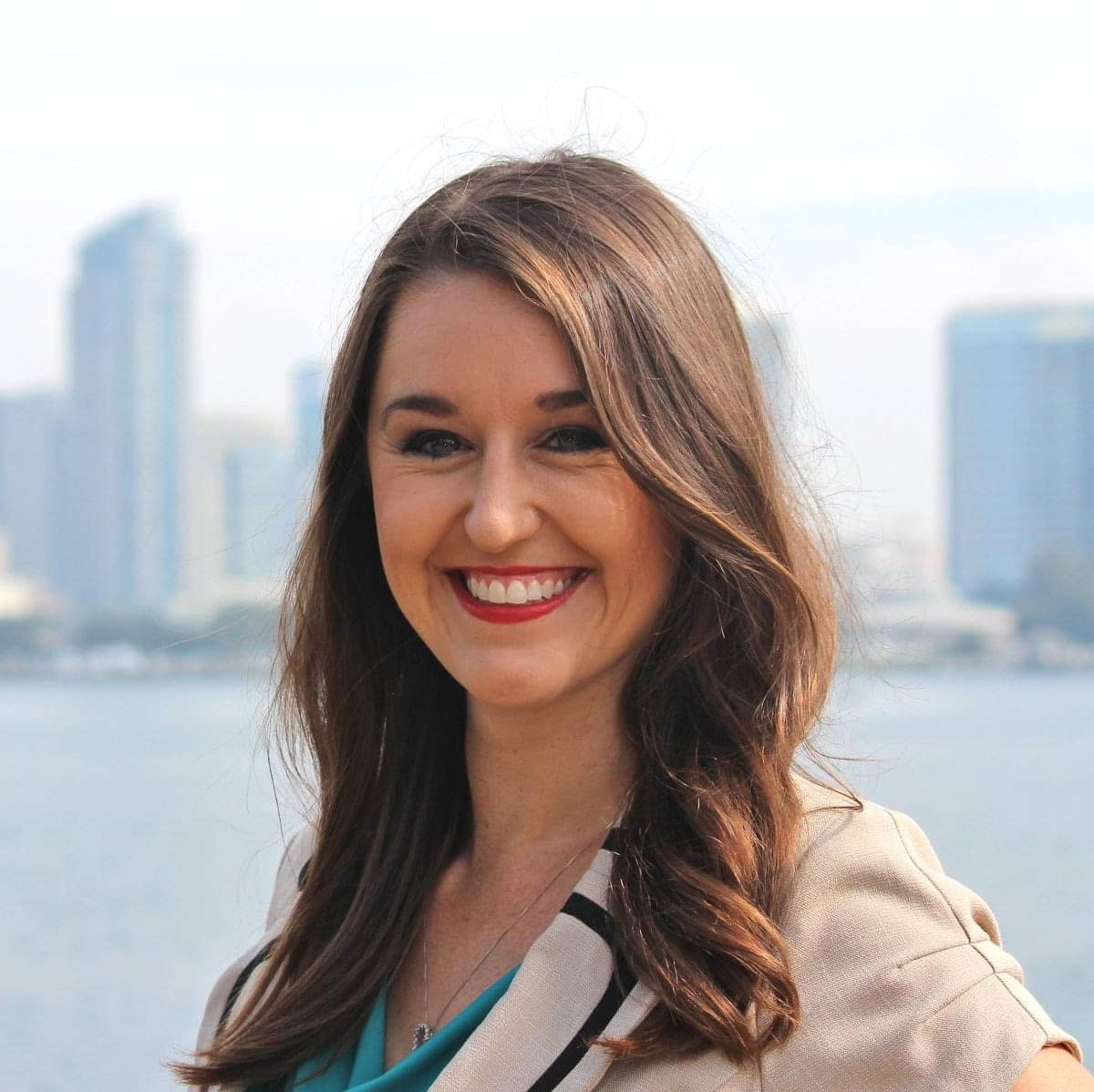 Smiling woman with cityscape in the background