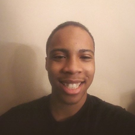 Christian Stewart, a young person with short hair smiling at the camera.